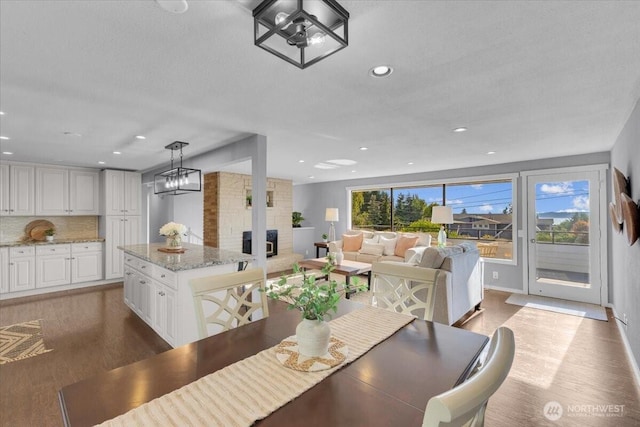 619 8th Ave S, Edmonds, WA 98020 - dining space with wood finished floors, recessed lighting, and a large fireplace