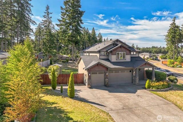 4749 NE Waxwing Ct, Lacey, WA 98516 - craftsman house featuring stone siding, driveway, a garage, an attached garage, and a shingled roof