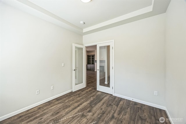4749 NE Waxwing Ct, Lacey, WA 98516 - spare room with dark wood-type flooring, a tray ceiling, french doors, and a smoke detector