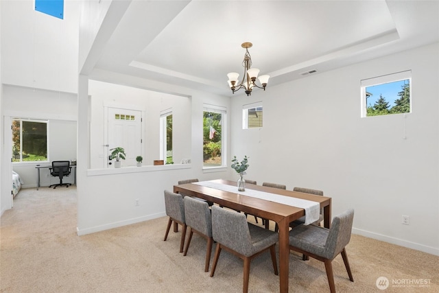 6821 9th St E, Fife, WA 98424 - dining space featuring a raised ceiling, a chandelier, and light carpet