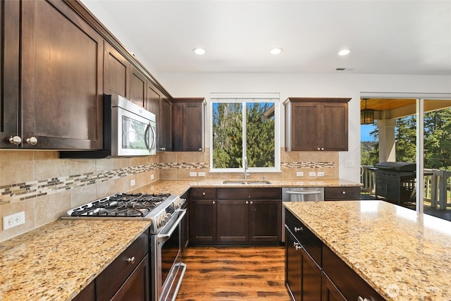 6821 9th St E, Fife, WA 98424 - kitchen featuring appliances with stainless steel finishes, plenty of natural light, dark wood-style flooring, backsplash, and recessed lighting
