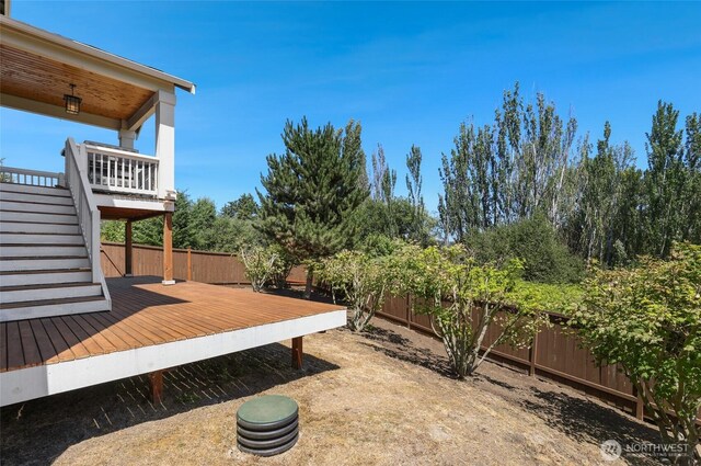 6821 9th St E, Fife, WA 98424 - fenced backyard featuring a wooden deck and stairway