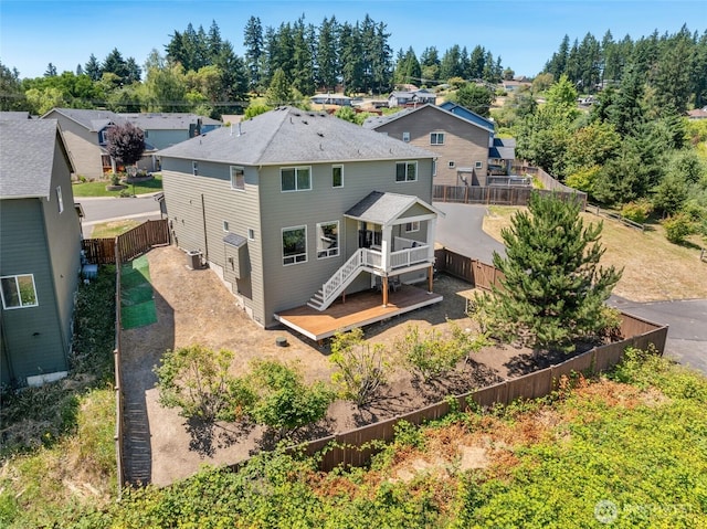 6821 9th St E, Fife, WA 98424 - back of property featuring a wooden deck, a fenced backyard, stairway, and a residential view