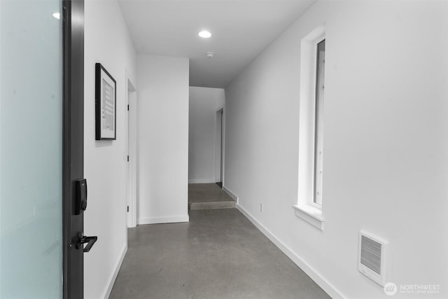 1327 N 185th St Unit A, Shoreline, WA 98133 - hall featuring finished concrete flooring, recessed lighting, and heating unit
