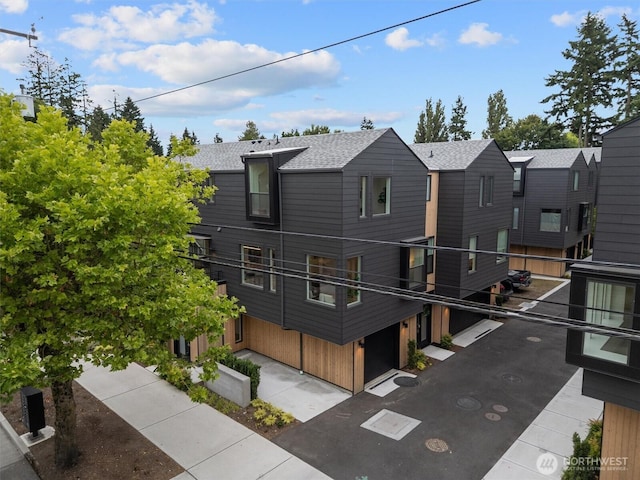 1327 N 185th St Unit A, Shoreline, WA 98133 - rear view of house featuring a shingled roof and a balcony