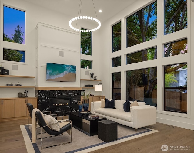 15734 SE 25th St, Bellevue, WA 98008 - living room featuring wood finished floors, a premium fireplace, recessed lighting, and plenty of natural light