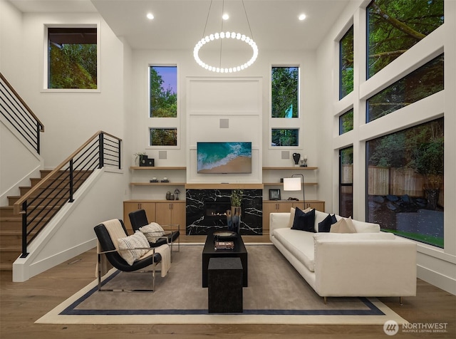 15734 SE 25th St, Bellevue, WA 98008 - living area featuring wood finished floors, recessed lighting, stairway, and a premium fireplace