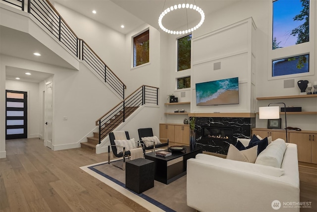 15734 SE 25th St, Bellevue, WA 98008 - living room with wood finished floors, stairway, a towering ceiling, a high end fireplace, and recessed lighting