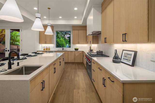 15734 SE 25th St, Bellevue, WA 98008 - kitchen featuring light brown cabinets, high end stove, plenty of natural light, light wood-type flooring, and recessed lighting