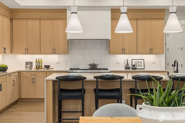 15734 SE 25th St, Bellevue, WA 98008 - kitchen with light brown cabinetry, light countertops, light wood-style floors, and decorative backsplash
