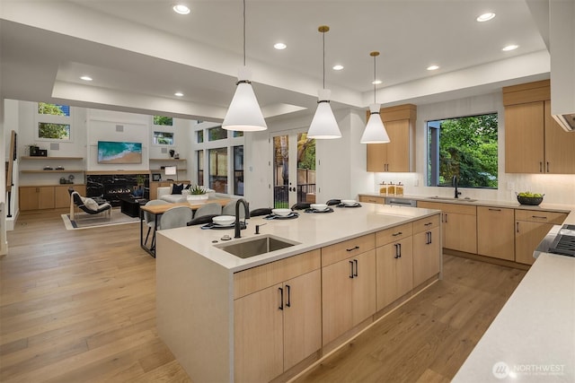 15734 SE 25th St, Bellevue, WA 98008 - kitchen featuring light brown cabinetry, a raised ceiling, open floor plan, a center island, and light wood-style flooring