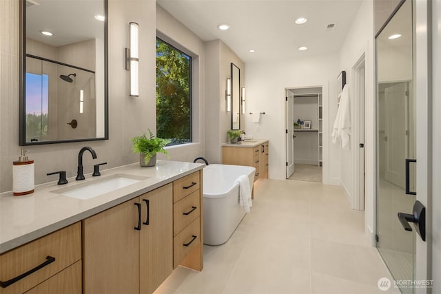 15734 SE 25th St, Bellevue, WA 98008 - full bathroom featuring a stall shower, two vanities, a soaking tub, recessed lighting, and a closet