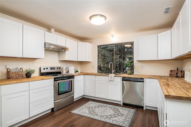 20632 76th Ave W Unit 4, Edmonds, WA 98026 - kitchen with butcher block countertops, appliances with stainless steel finishes, under cabinet range hood, dark wood finished floors, and white cabinets