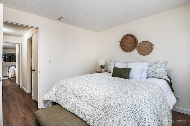 20632 76th Ave W Unit 4, Edmonds, WA 98026 - bedroom featuring dark wood finished floors and a textured ceiling