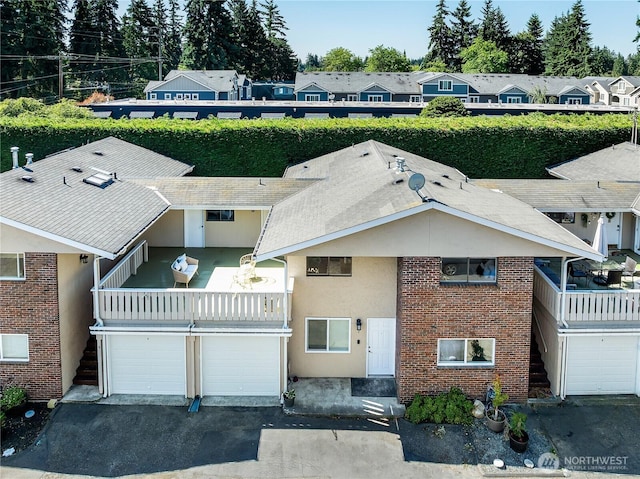 20632 76th Ave W Unit 4, Edmonds, WA 98026 - view of property featuring asphalt driveway and a garage