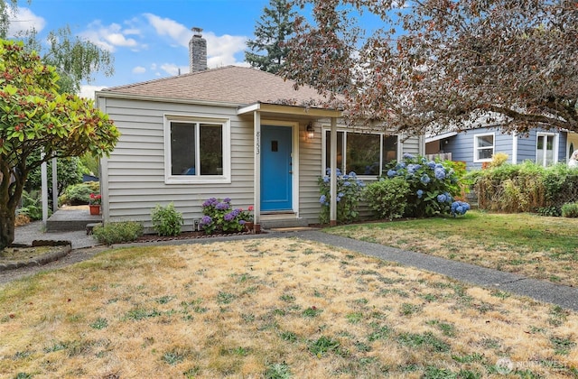 8153 34th Ave SW, Seattle, WA 98126 - bungalow-style home featuring a front lawn, a chimney, and roof with shingles