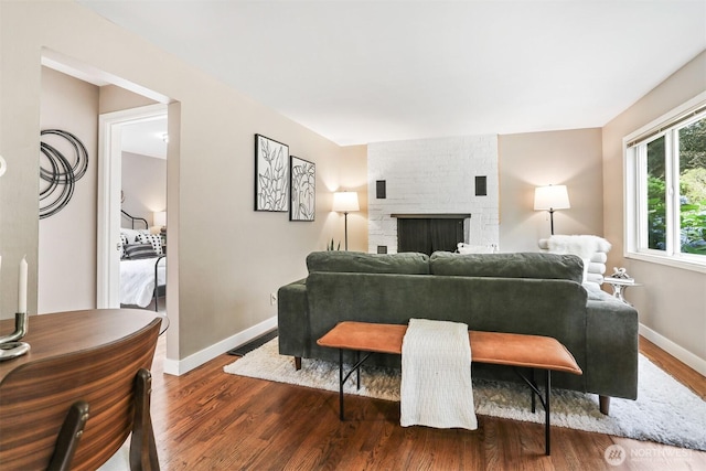 8153 34th Ave SW, Seattle, WA 98126 - living area featuring dark wood finished floors and a brick fireplace