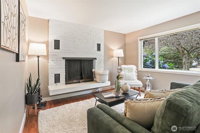 8153 34th Ave SW, Seattle, WA 98126 - living room with wood finished floors and a brick fireplace