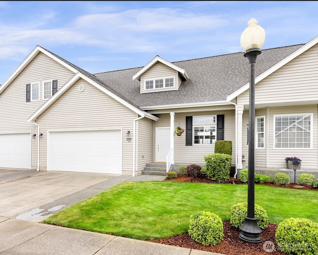 1725 Harrison Pl Unit 104, Lynden, WA 98264 - traditional-style house featuring concrete driveway, a front lawn, a shingled roof, and a garage