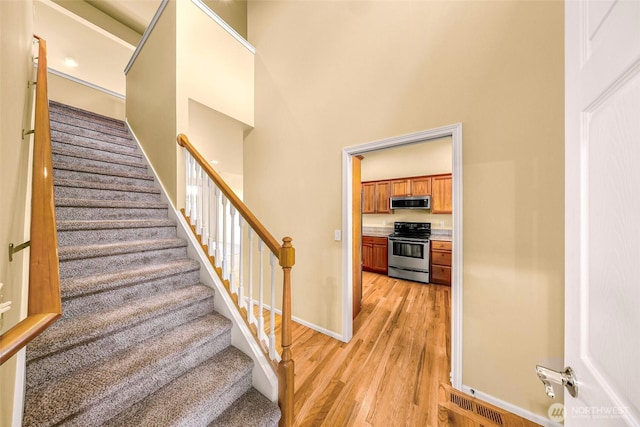 1725 Harrison Pl Unit 104, Lynden, WA 98264 - stairway featuring wood finished floors and a high ceiling