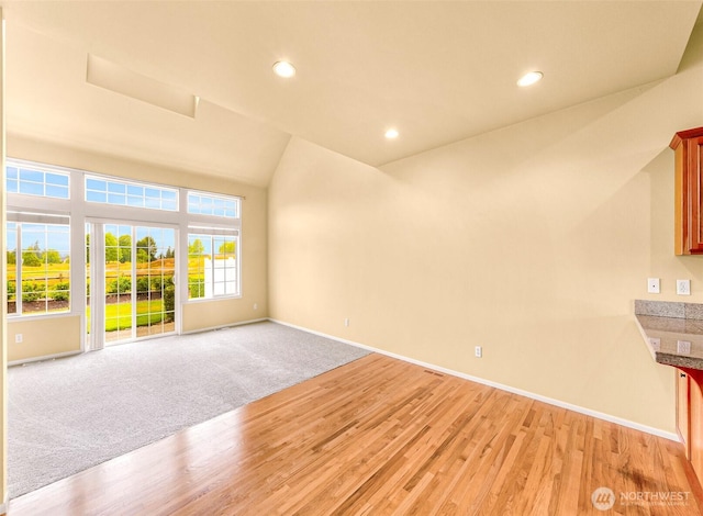 1725 Harrison Pl Unit 104, Lynden, WA 98264 - unfurnished room with light wood-type flooring, lofted ceiling, and recessed lighting