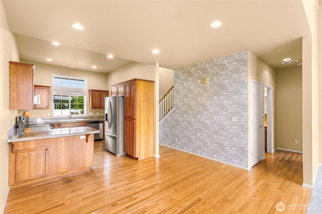 1725 Harrison Pl Unit 104, Lynden, WA 98264 - kitchen with appliances with stainless steel finishes, a peninsula, light wood-style floors, light countertops, and recessed lighting