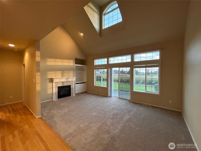1725 Harrison Pl Unit 104, Lynden, WA 98264 - unfurnished living room featuring high vaulted ceiling, a tile fireplace, carpet floors, and recessed lighting