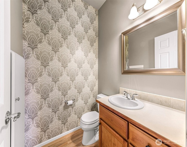 1725 Harrison Pl Unit 104, Lynden, WA 98264 - bathroom featuring wallpapered walls, vanity, and wood finished floors
