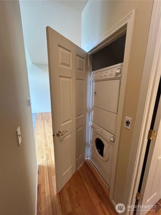 1725 Harrison Pl Unit 104, Lynden, WA 98264 - washroom featuring estacked washer and dryer and light wood finished floors