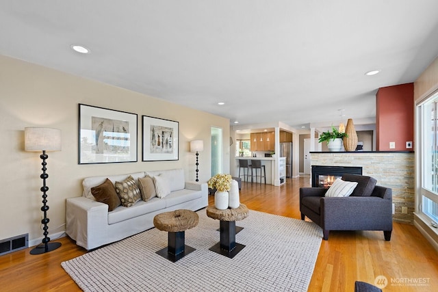 9423 45th Ave SW, Seattle, WA 98136 - living area with light wood-style flooring, recessed lighting, and a stone fireplace