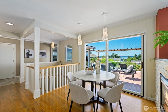 9423 45th Ave SW, Seattle, WA 98136 - dining area featuring light wood-style floors and a glass covered fireplace