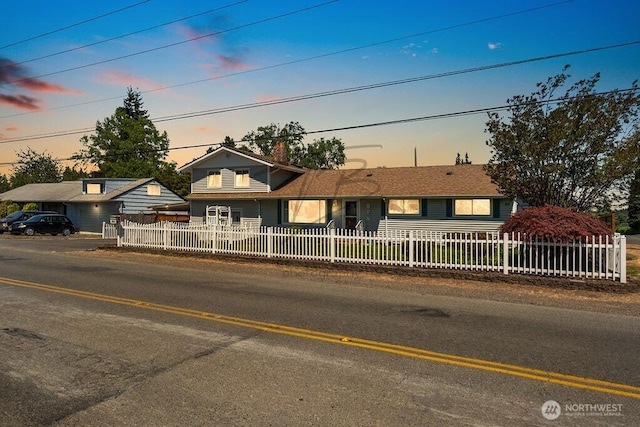 1727 E 64th St, Tacoma, WA 98404 - view of front of house with a fenced front yard and a chimney