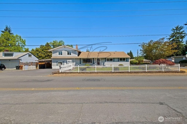 1727 E 64th St, Tacoma, WA 98404 - view of front of property featuring a carport, a fenced front yard, and concrete driveway