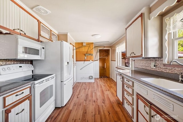 1727 E 64th St, Tacoma, WA 98404 - kitchen featuring white appliances, light wood-style flooring, dark countertops, and ornamental molding