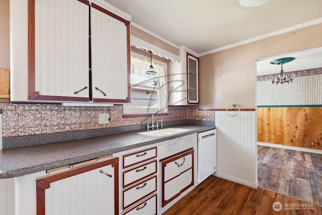 1727 E 64th St, Tacoma, WA 98404 - kitchen featuring white dishwasher, dark countertops, dark wood-style floors, a chandelier, and backsplash