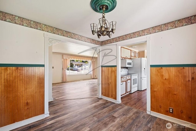 1727 E 64th St, Tacoma, WA 98404 - unfurnished dining area with a chandelier, wood finished floors, and wainscoting