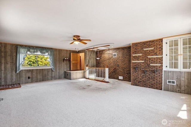 1727 E 64th St, Tacoma, WA 98404 - unfurnished living room featuring ceiling fan, carpet floors, and wooden walls