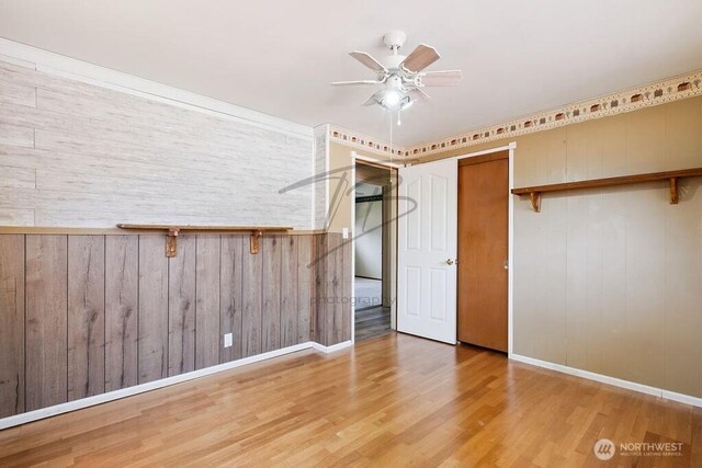 1727 E 64th St, Tacoma, WA 98404 - unfurnished bedroom with wood finished floors and wooden walls