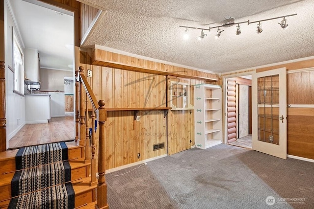 1727 E 64th St, Tacoma, WA 98404 - unfurnished bedroom with a textured ceiling, wooden walls, french doors, and crown molding