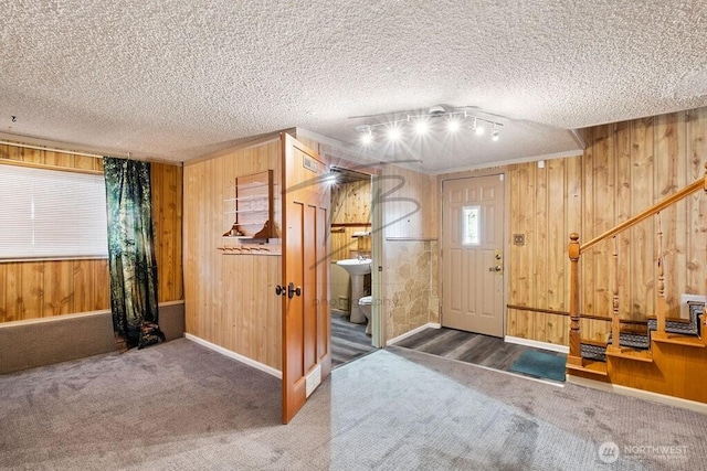 1727 E 64th St, Tacoma, WA 98404 - foyer entrance with carpet, wooden walls, and a textured ceiling