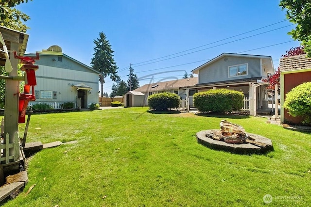 1727 E 64th St, Tacoma, WA 98404 - view of green lawn with a storage shed and a fire pit