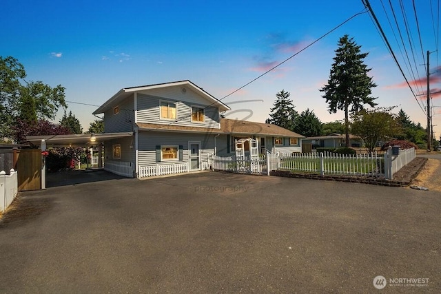 1727 E 64th St, Tacoma, WA 98404 - view of front of house featuring asphalt driveway, a fenced front yard, and an attached carport