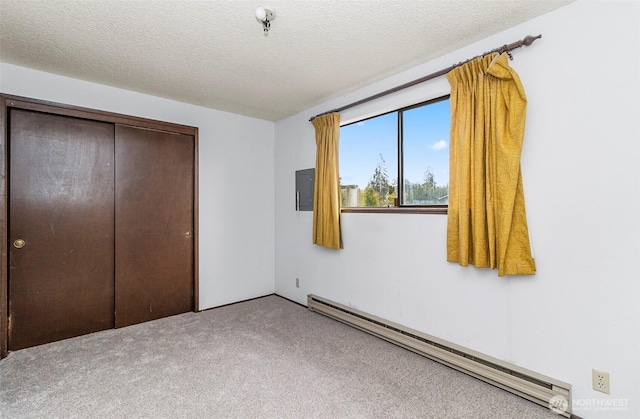1200 Lenora Ct, Bellingham, WA 98225 - unfurnished bedroom with a baseboard radiator, carpet flooring, a closet, a textured ceiling, and electric panel