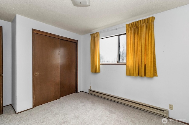 1200 Lenora Ct, Bellingham, WA 98225 - unfurnished bedroom featuring baseboard heating, carpet flooring, a closet, and a textured ceiling