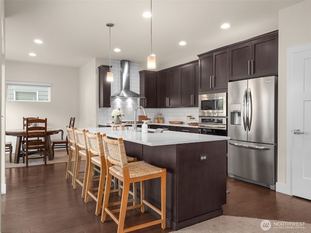 4419 141st Pl SE, Snohomish, WA 98296 - kitchen featuring appliances with stainless steel finishes, wall chimney exhaust hood, tasteful backsplash, dark brown cabinetry, and light countertops