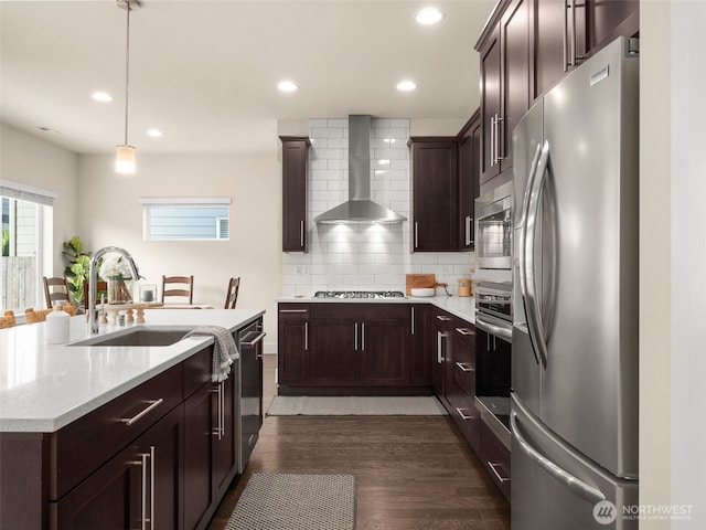 4419 141st Pl SE, Snohomish, WA 98296 - kitchen featuring stainless steel appliances, wall chimney range hood, dark brown cabinetry, decorative backsplash, and dark wood finished floors