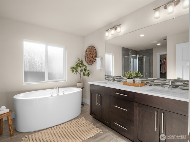 4419 141st Pl SE, Snohomish, WA 98296 - full bathroom with double vanity, a stall shower, tasteful backsplash, a freestanding tub, and a walk in closet