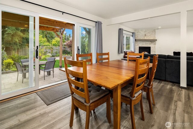 830 Mill Ave, Snohomish, WA 98290 - dining area with a stone fireplace and light wood-style floors