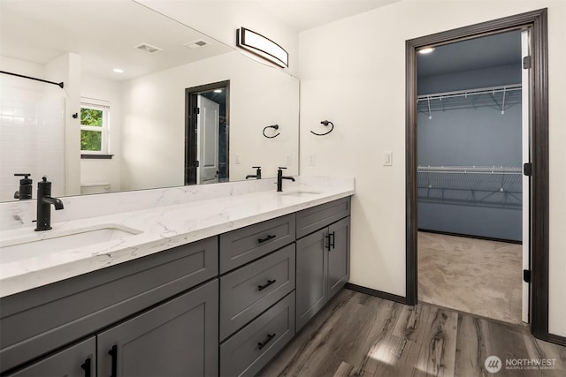 830 Mill Ave, Snohomish, WA 98290 - bathroom with wood finished floors, double vanity, and a spacious closet