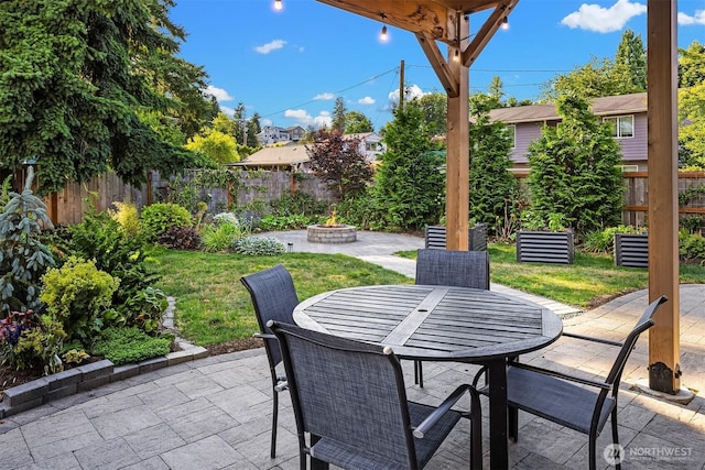 830 Mill Ave, Snohomish, WA 98290 - fenced backyard with a patio, an outdoor fire pit, and outdoor dining space